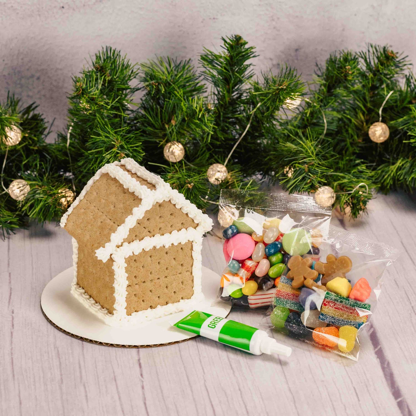 A ready-to-decorate gingerbread house kit featuring a fully assembled gingerbread house; made out of Graham Crackers, assorted colorful candies, and tube of icing (colors vary) —everything you need to add your own festive decorations with no building required. For in-store pickup in West Liberty, Ohio ONLY!
