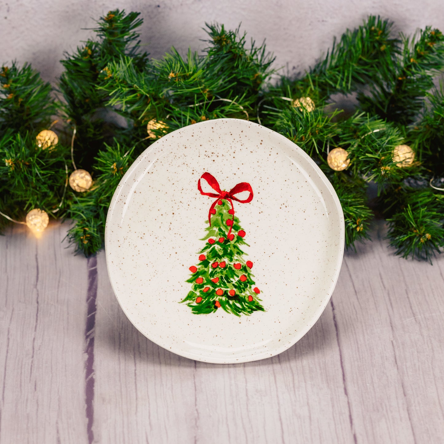 over a half pound of milk chocolate foil bells are packaged with this round hand painted tree dessert plate.