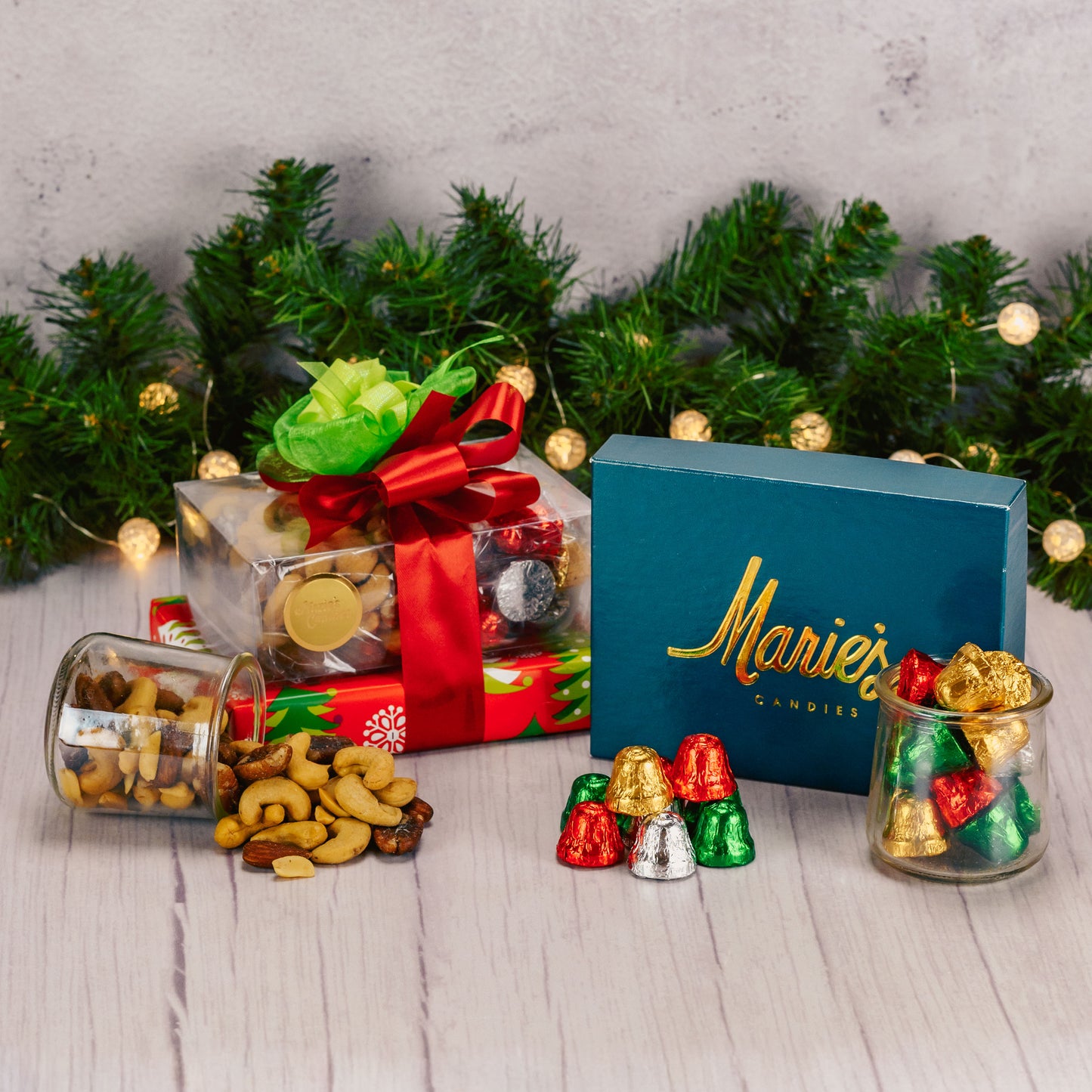 a small gift stack wrapped and tied in traditional red and greens is a lovely gift of appreciation this holiday. Includes an assorted box of chocolates, roasted & salted mixed nuts and milk chocolate foil bells.