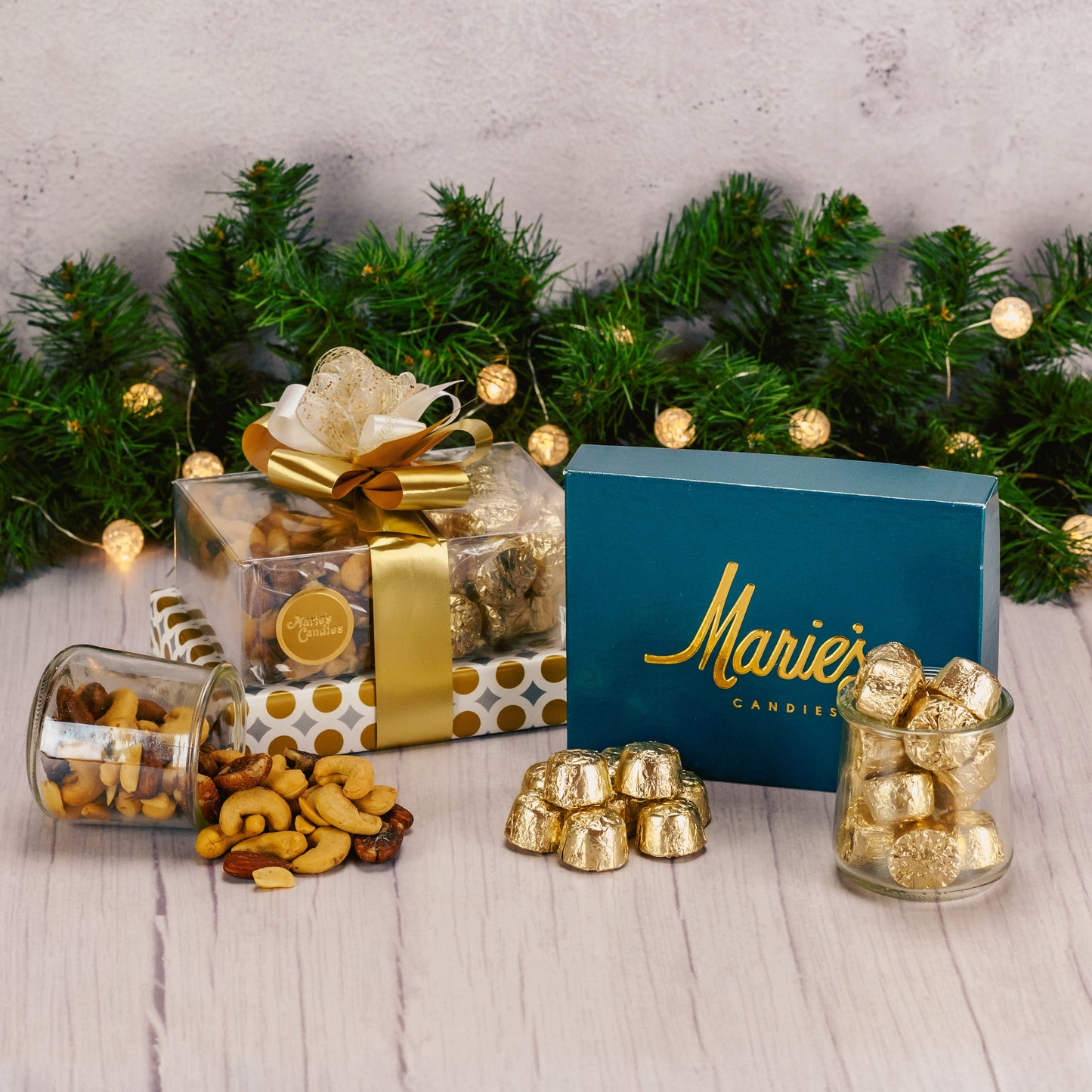 a lovely gift stack wrapped in gold is packaged with an assorted box of chocolates, roasted & salted mixed nuts and milk chocolate foil wrapped nuggets.