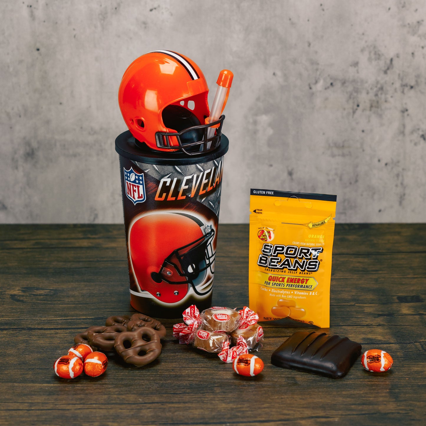 A Cleveland Browns NFL official cup with straw and detectable football helmet cup is filled with sweet treats.