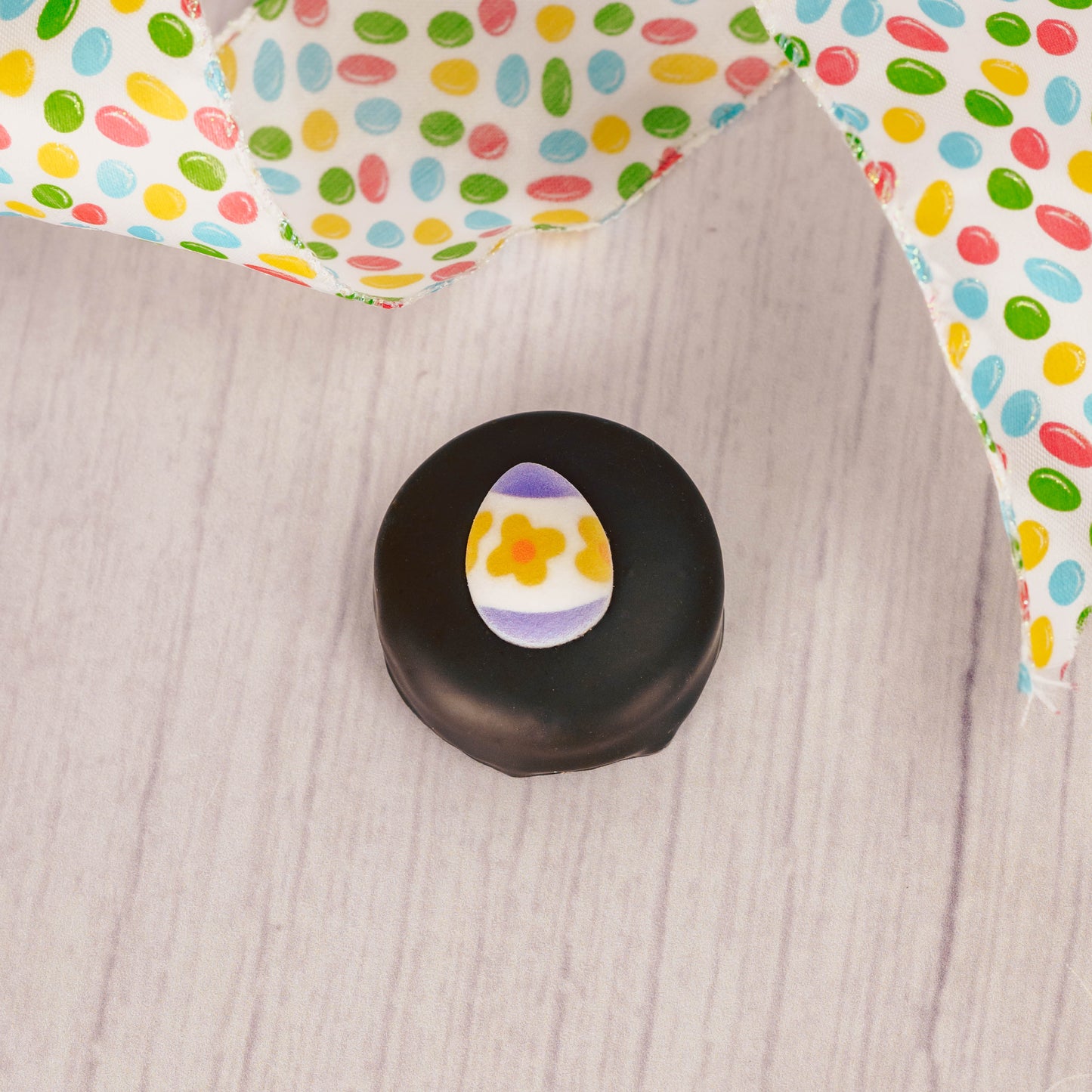 Dark chocolate covered Oreo with an Easter egg sugar decoration on top