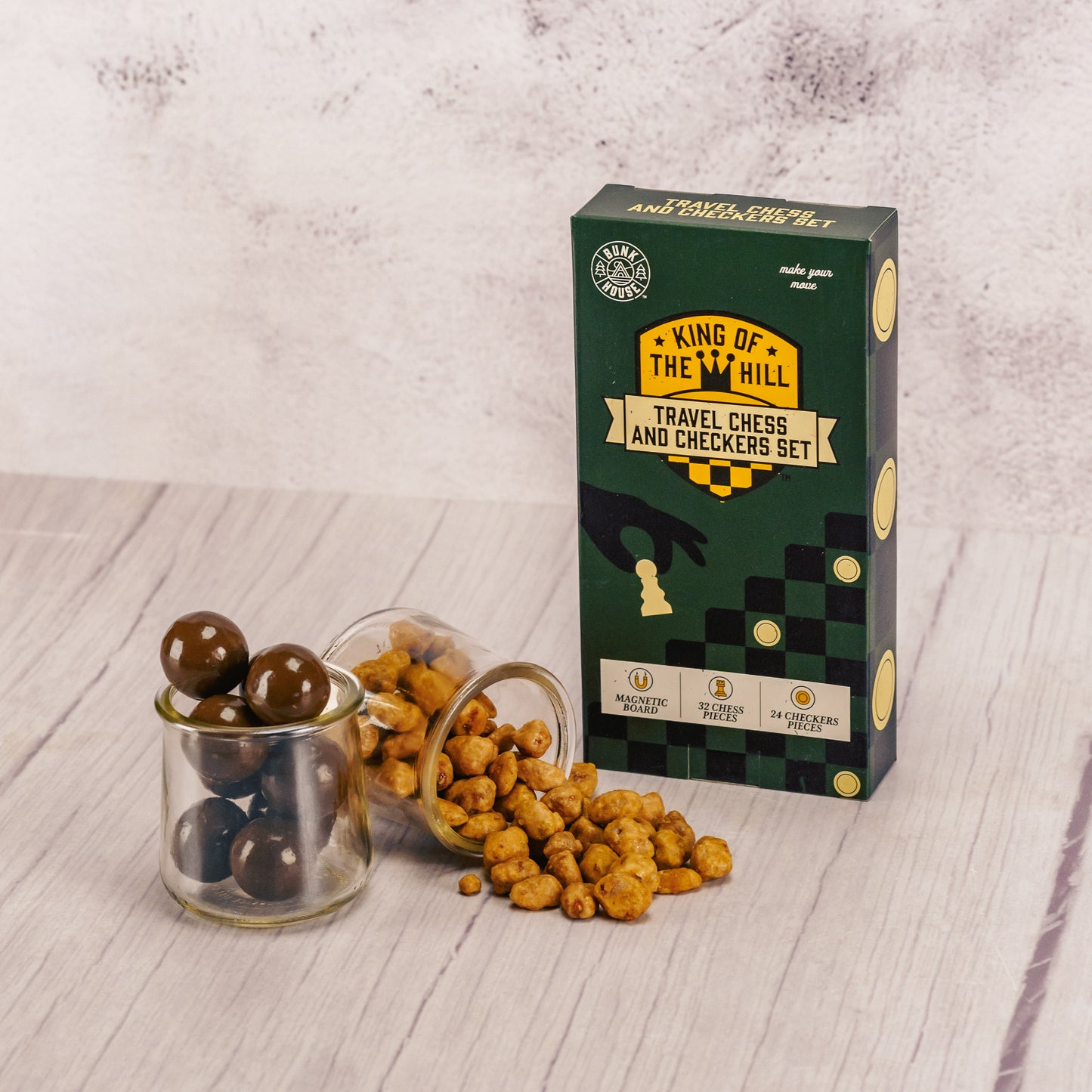 a travel magnetic chess and checkers game set is packaged with some malt balls and butter toffee peanuts
