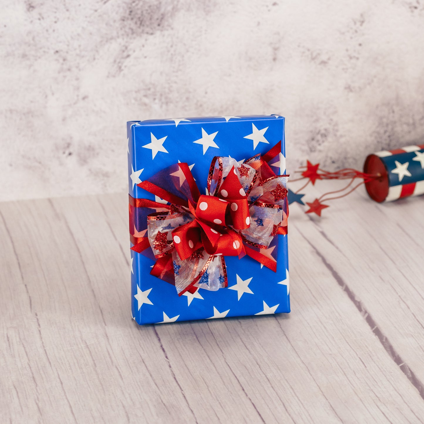 a half pound box of assorted chocolates is wrapped festively patriotic.