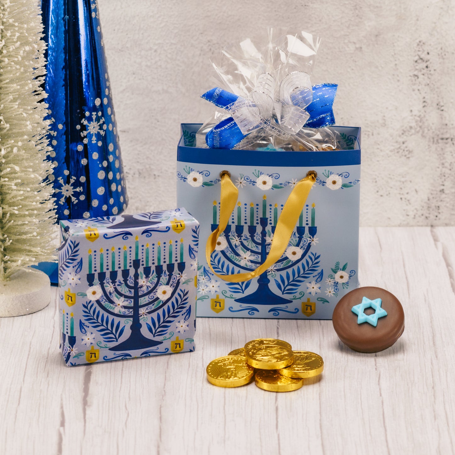 Gift bag with Menorah design filled with sweet treats for Hanukkah.