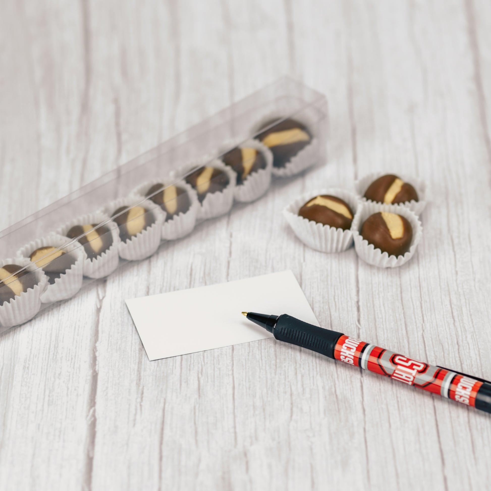 a quarter pound box of our Buckeyes is topped with an Ohio State Pen