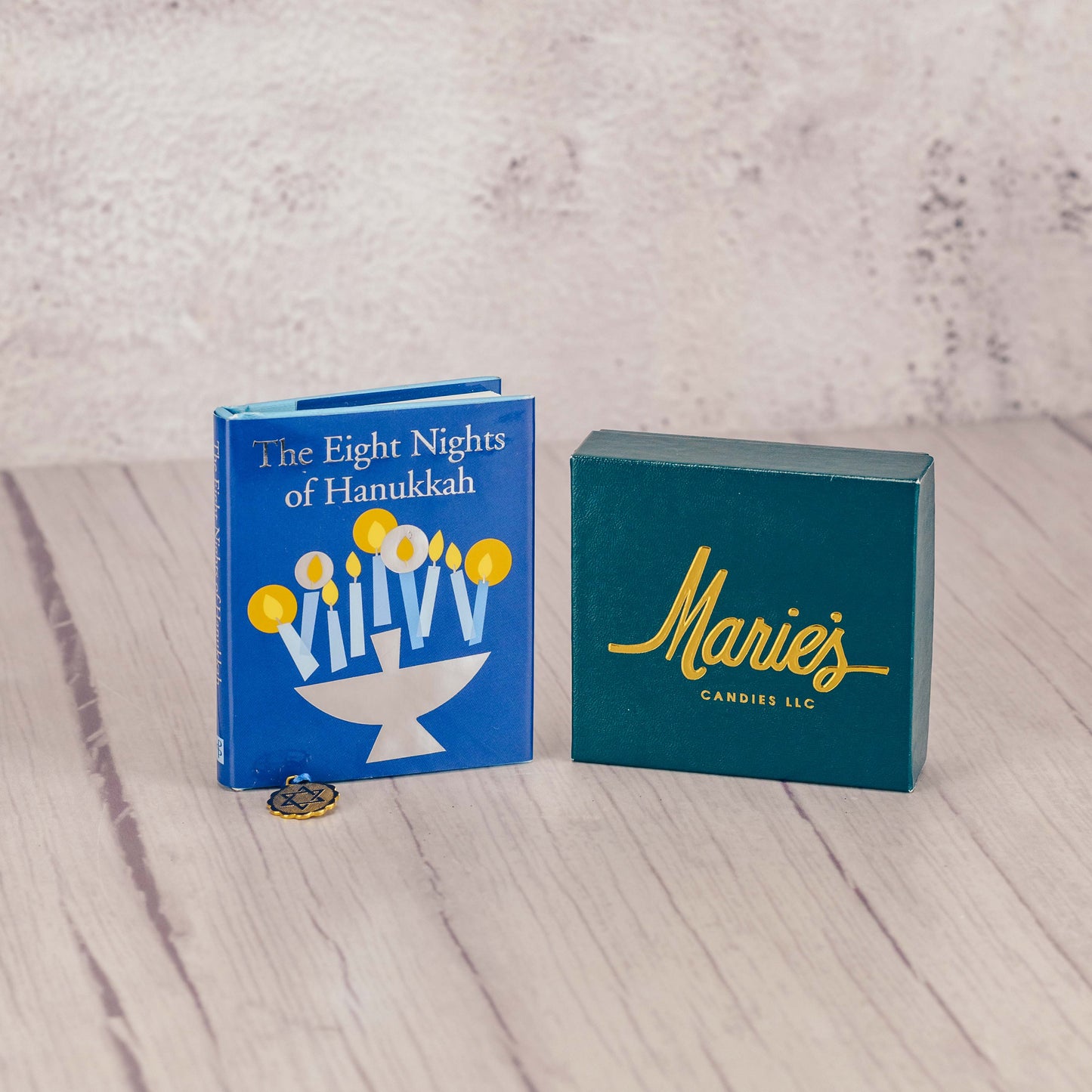 A sampler box of assorted chocolates packaged with a petite book about Hanukkah 'The Eight Nights of Hanukkah'