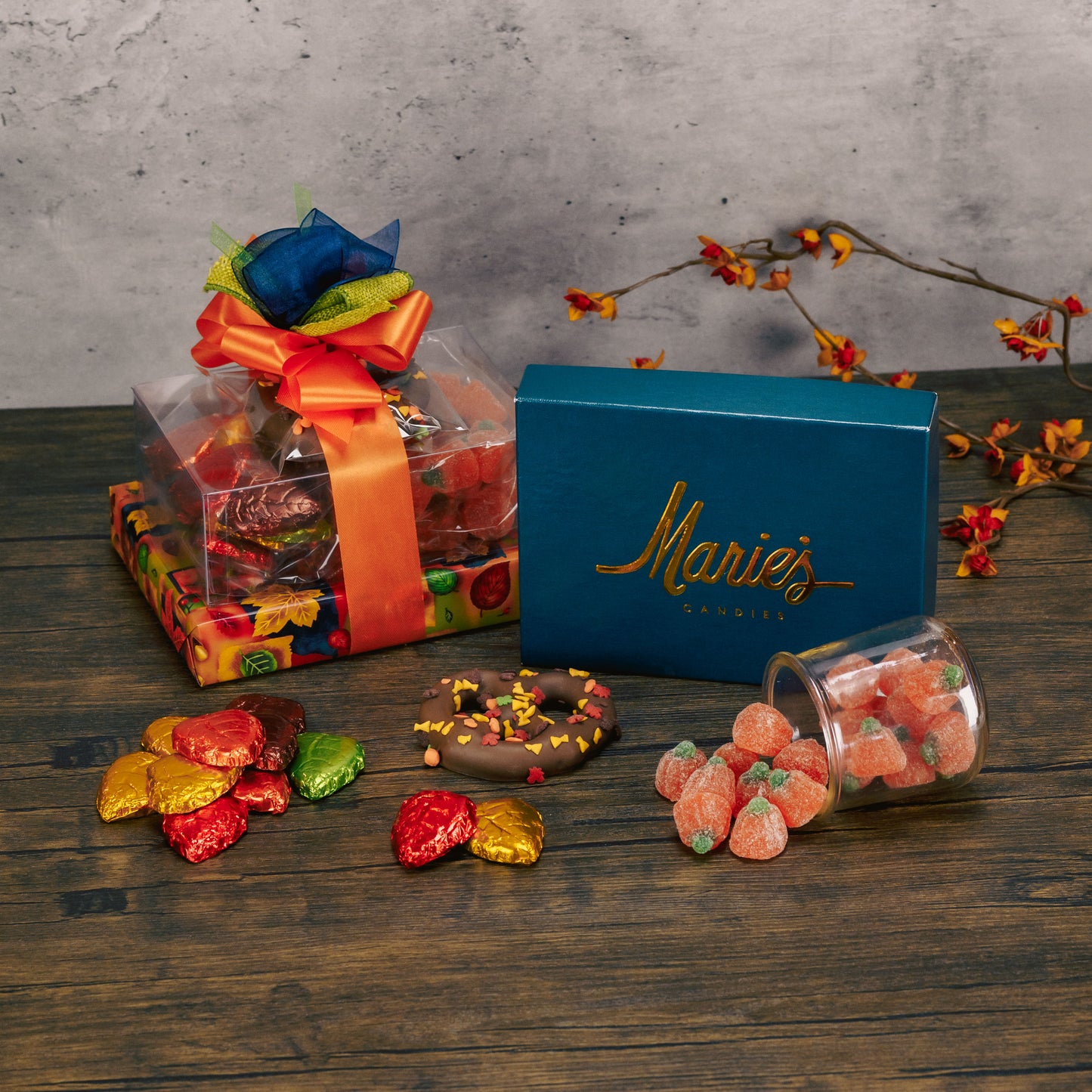 a small fall themed gift stack is wrapped in fall with sweet treats