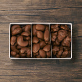 A one pound box of milk chocolate covered nuts like roasted cashews, pecans, and peanuts.