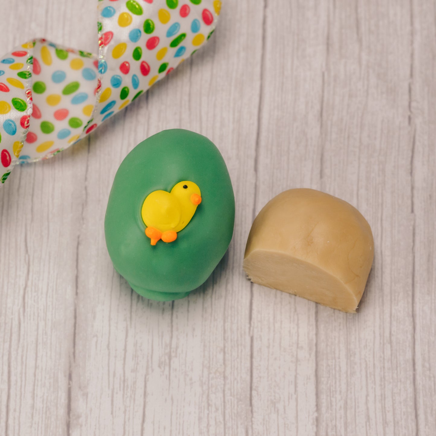 Butter cream and cream fondant center formed in egg shape covered in milk chocolate or green coating in various sizes.