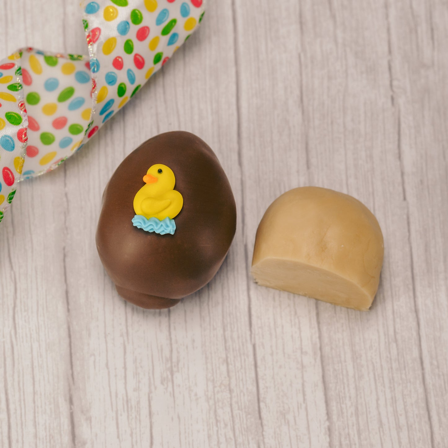 Butter cream and cream fondant center formed in egg shape covered in milk chocolate or green coating in various sizes.