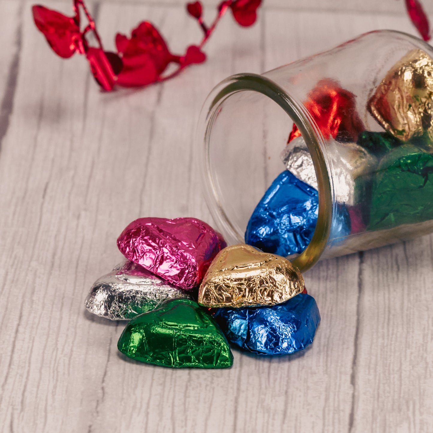 half pound bag of milk chocolate hearts wrapped in rainbow colored foil