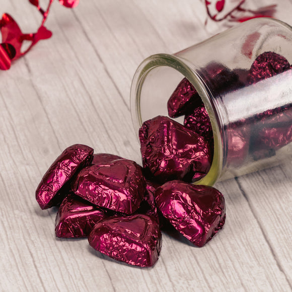 Solid premium 72% dark chocolate hearts, wrapped in burgundy foil. Packaged in half pound bags with approximately 27 pieces.