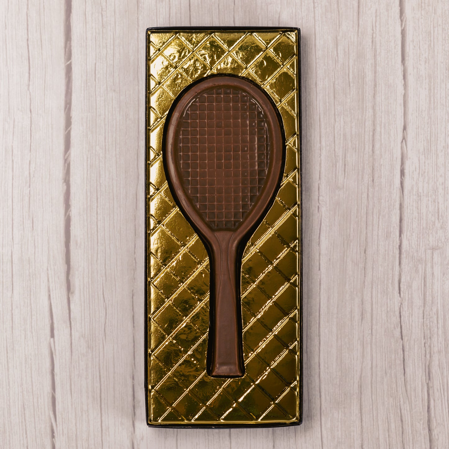 milk chocolate tennis racquet in a box.