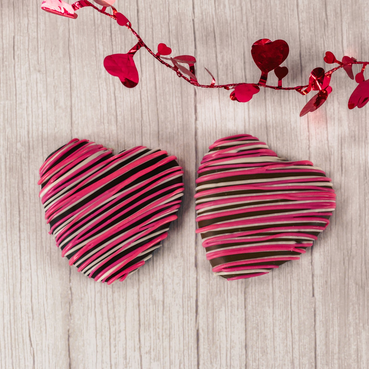 a wonderful marshmallow heart treat dipped in smooth milk chocolate or rich dark chocolate and drizzled with pink and white icing.