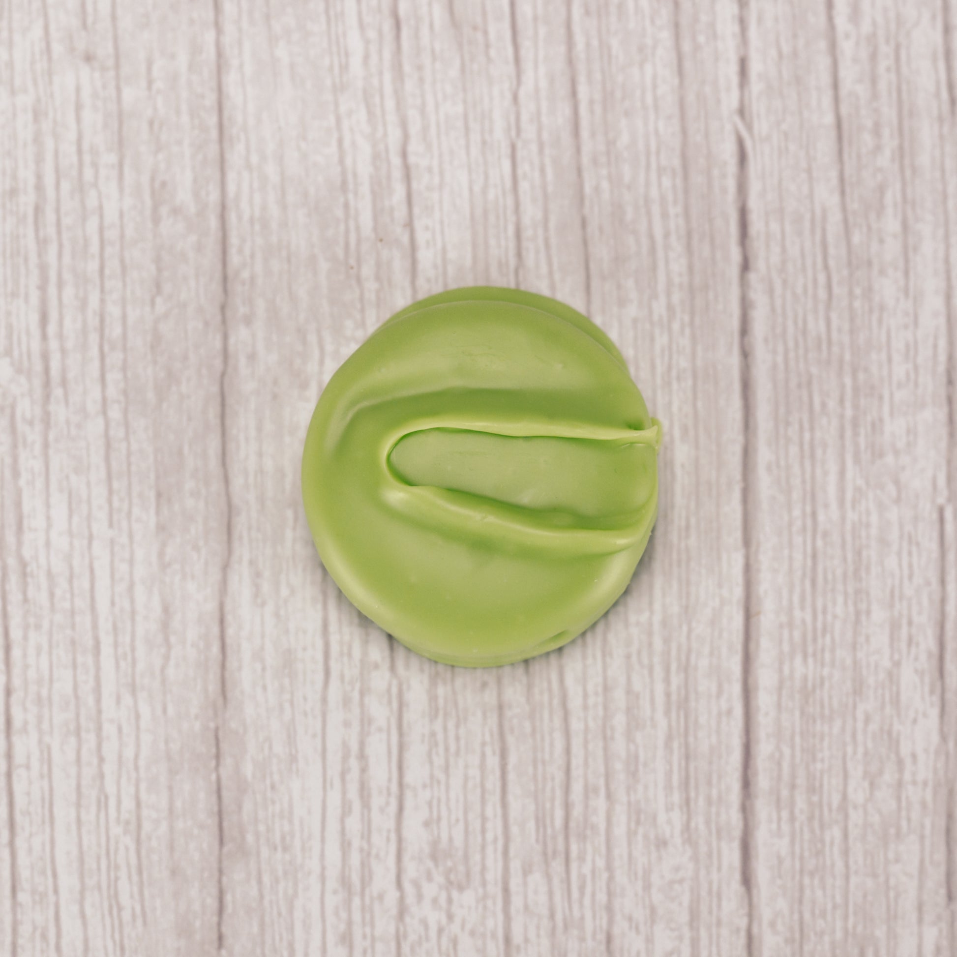 Oreo cookie covered in green coating with mint flavor. Individually wrapped