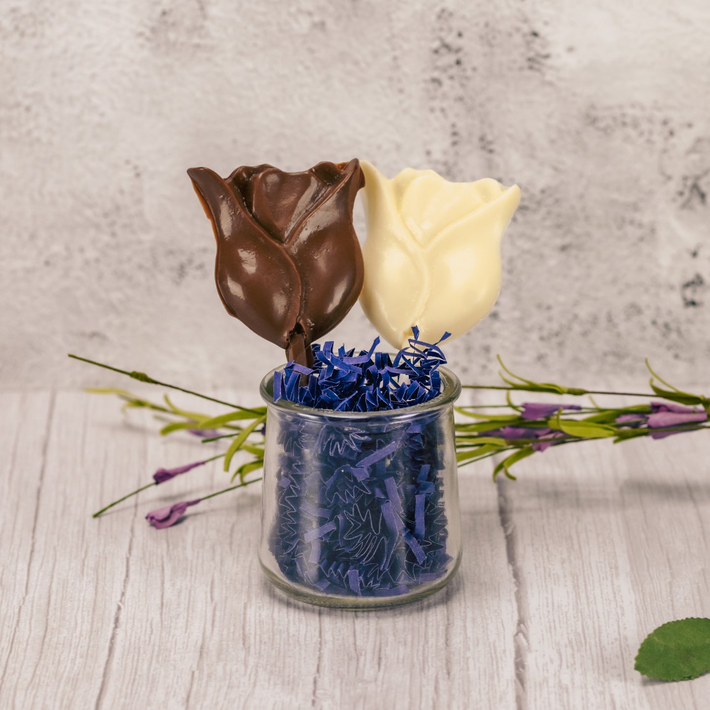 A tulip flower in milk chocolate or white coating on a sucker stick