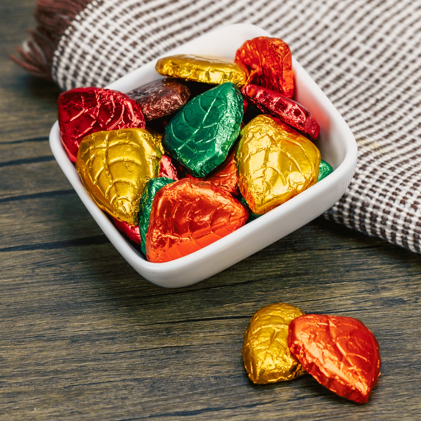 Milk chocolate shaped leaves wrapped in foil fall colors.