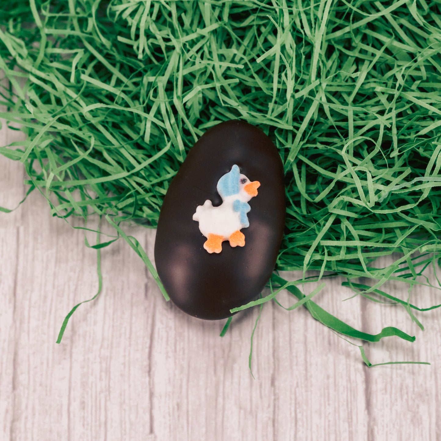 A bite- sized fluffy marshmallow center with a dollop of caramel egg is covered in smooth rich dark chocolate and topped with an Easter sugar decoration.