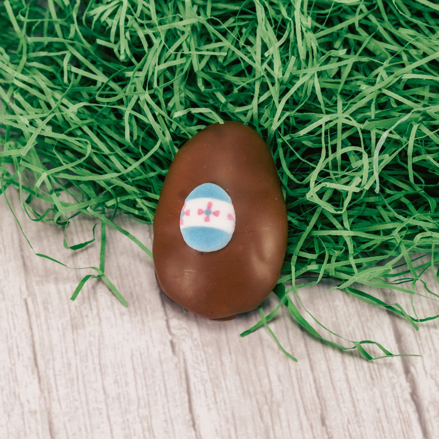 A bite- sized fluffy marshmallow center with a dollop of caramel egg is covered in smooth milk chocolate and topped with an Easter sugar decoration.