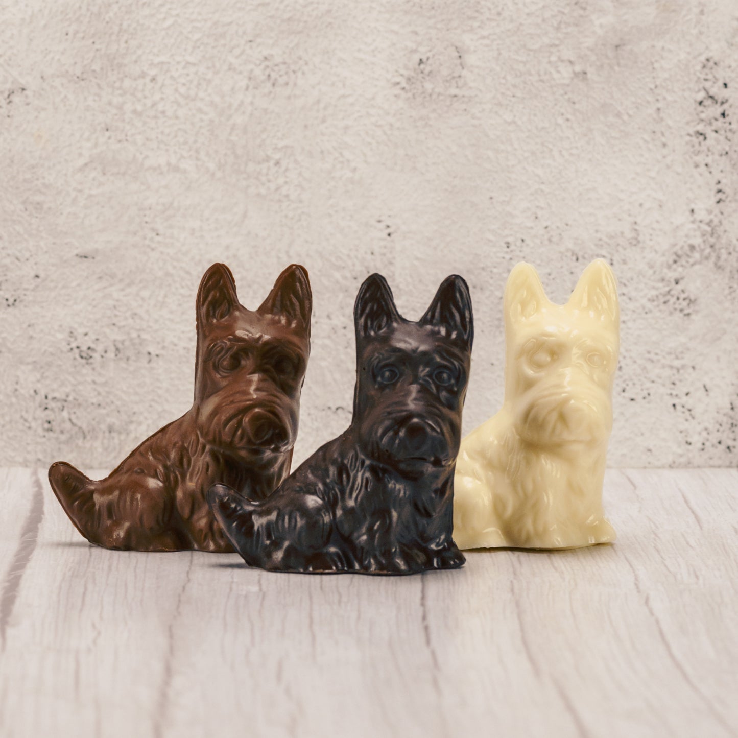 A scottie dog in milk chocolate, dark chocolate or white coating.