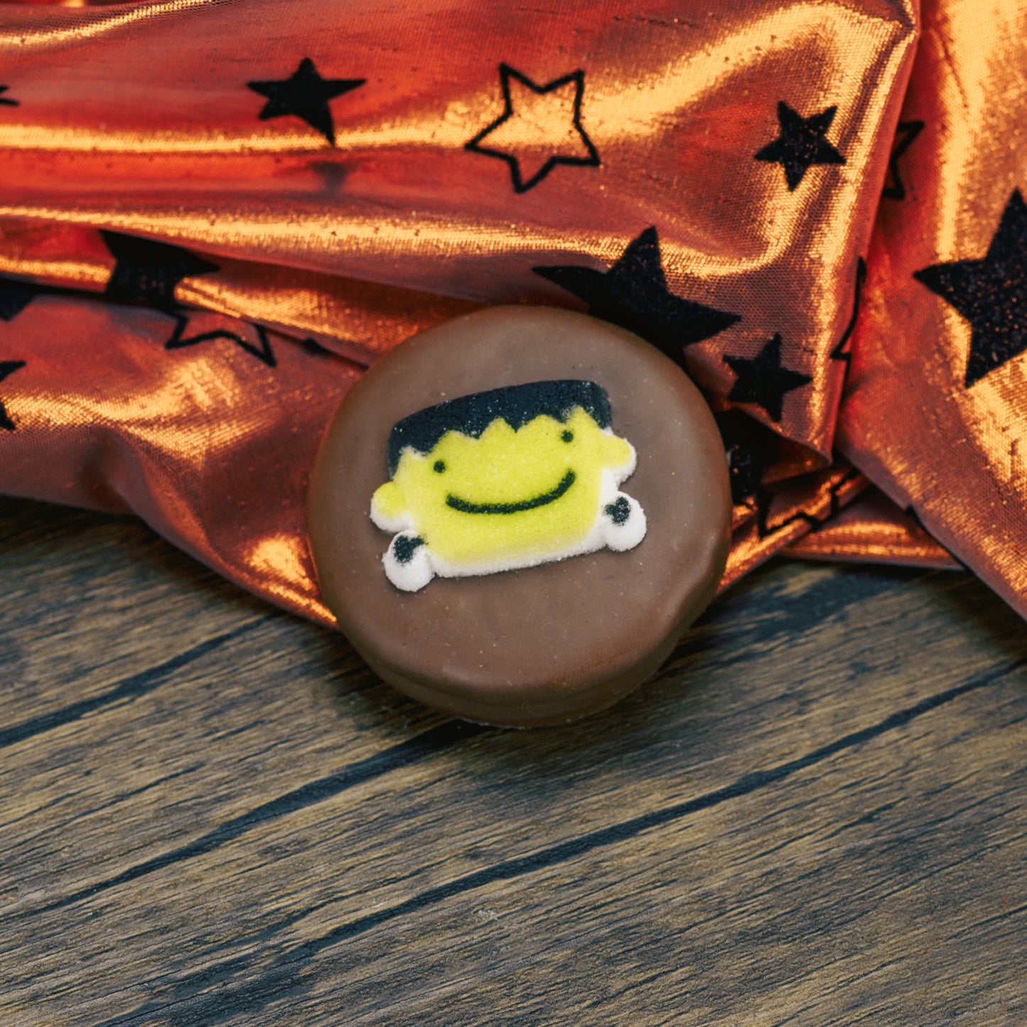 Oreo cookies covered in milk chocolate.Each with a sugar Halloween decoration on top.
