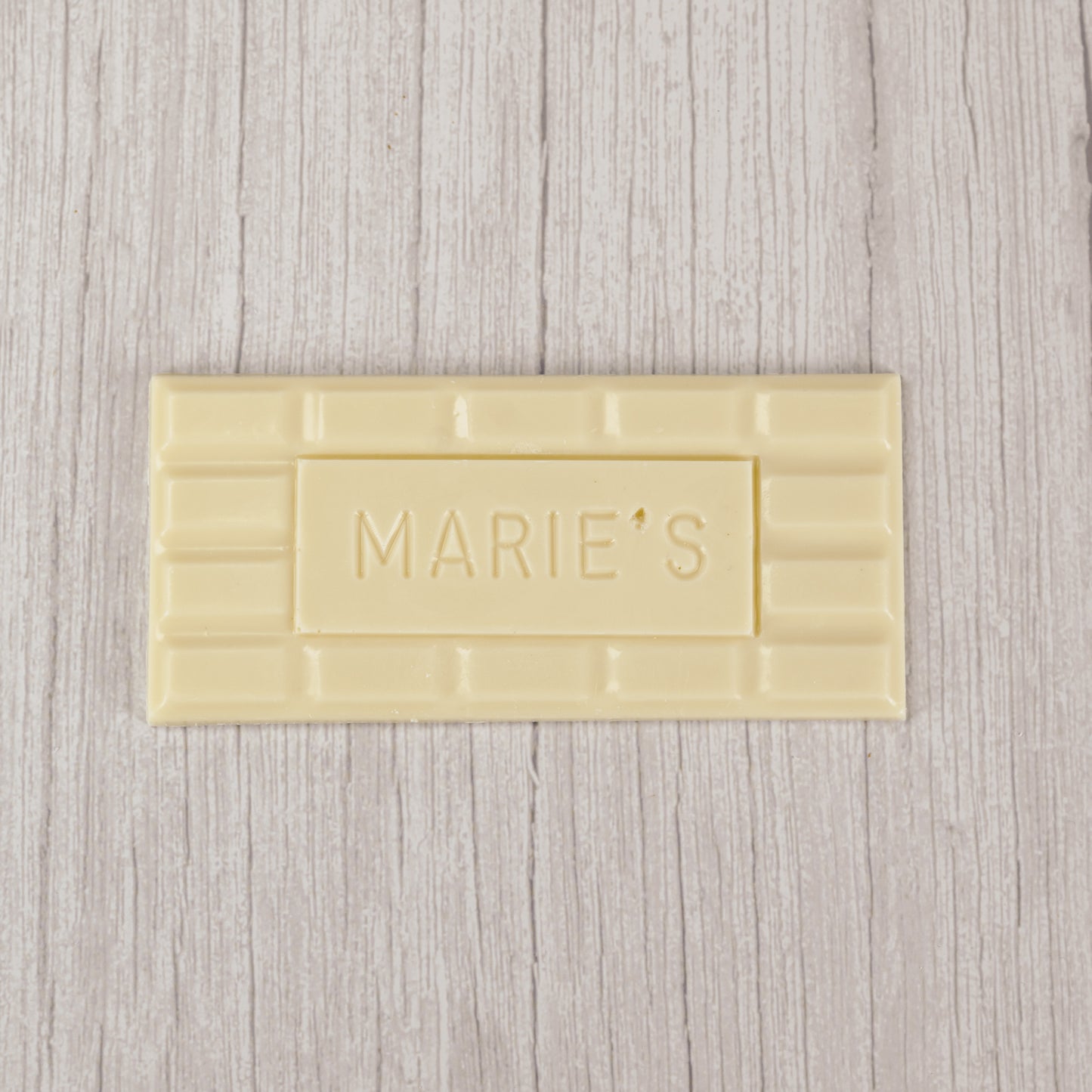 white coating molded into a bar that says "Marie's"