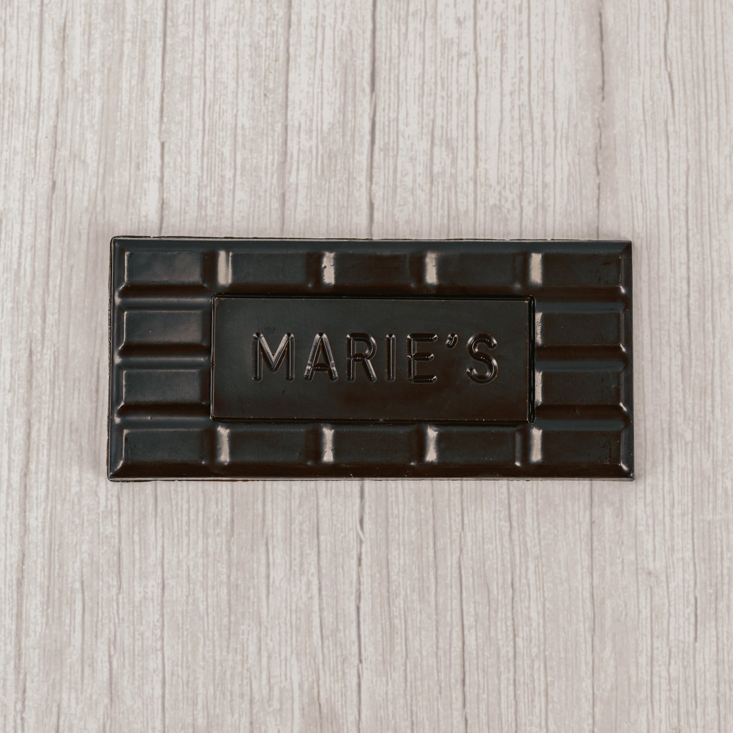 dark chocolate molded into a bar that says "Marie's"