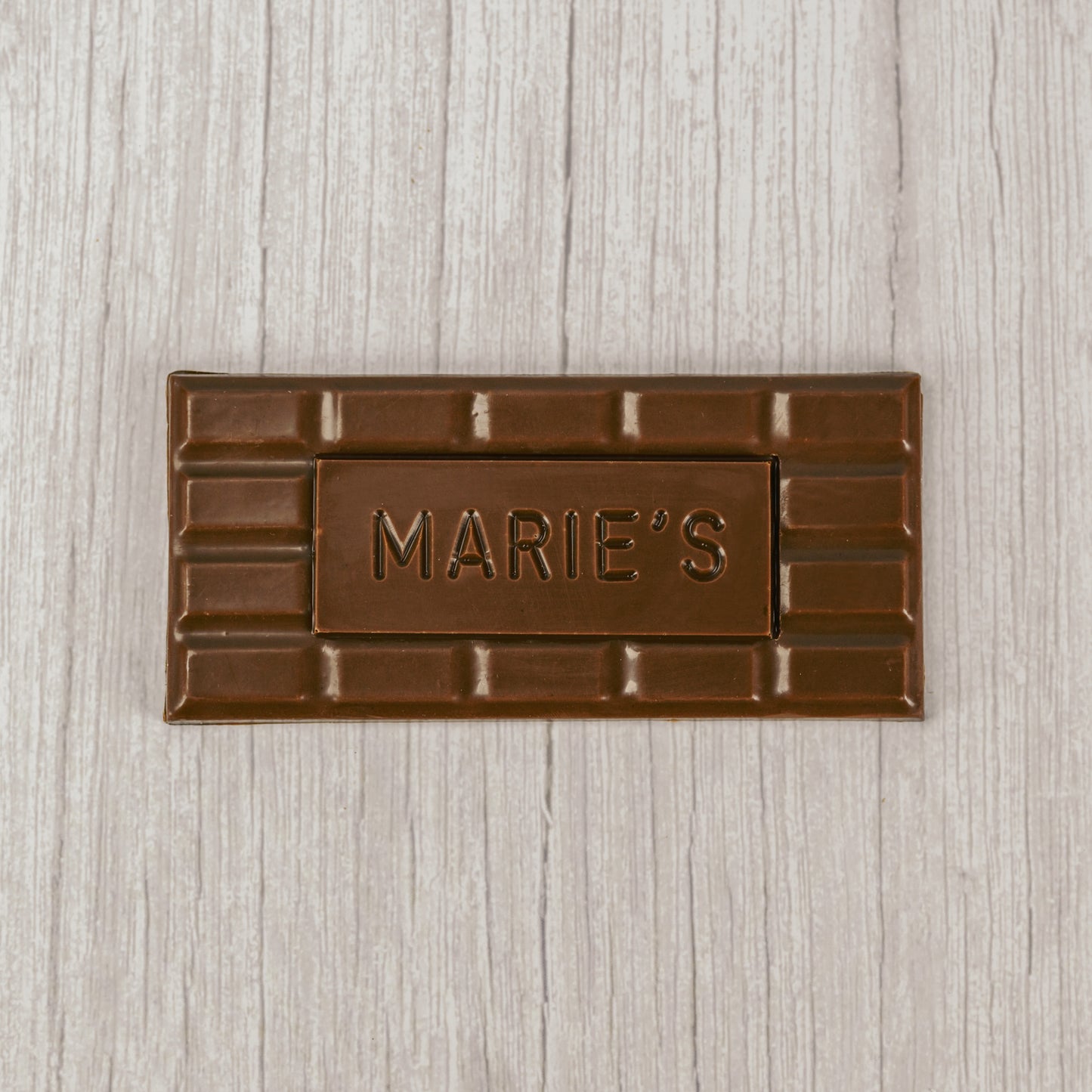 Milk chocolate molded into a bar that says "Marie's"
