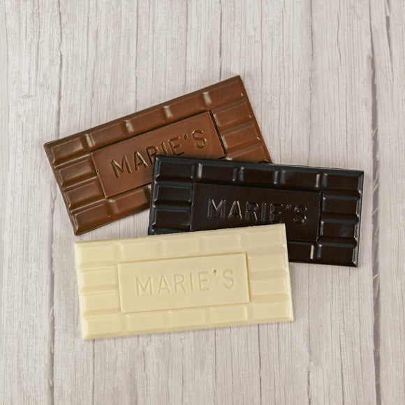 Milk chocolate, dark chocolate or white coating molded into a bar that says 