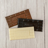 Milk chocolate, dark chocolate or white coating molded into a bar that says "Marie's"
