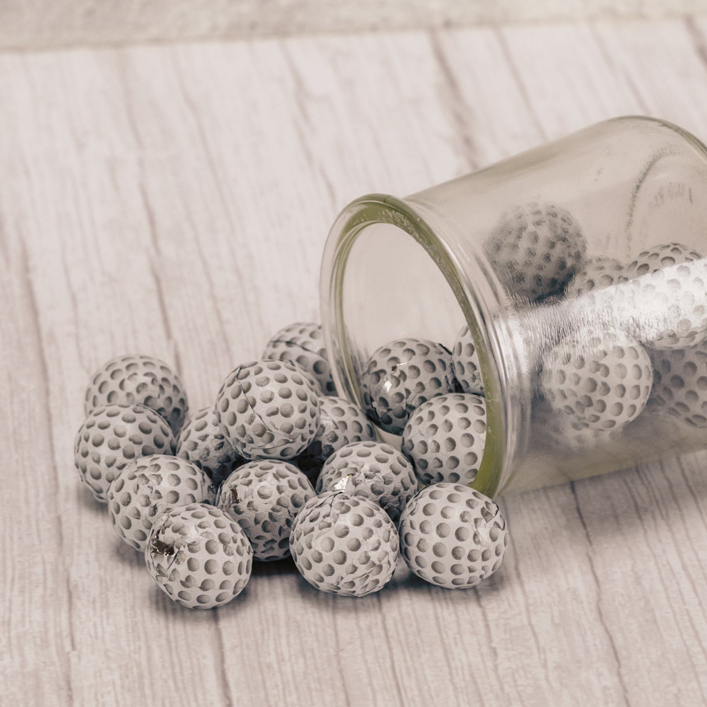 bite size milk chocolate balls wrapped in golf ball foil in a half pound bag.