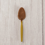 A plastic spoon dipped in milk chocolate. Individually wrapped.