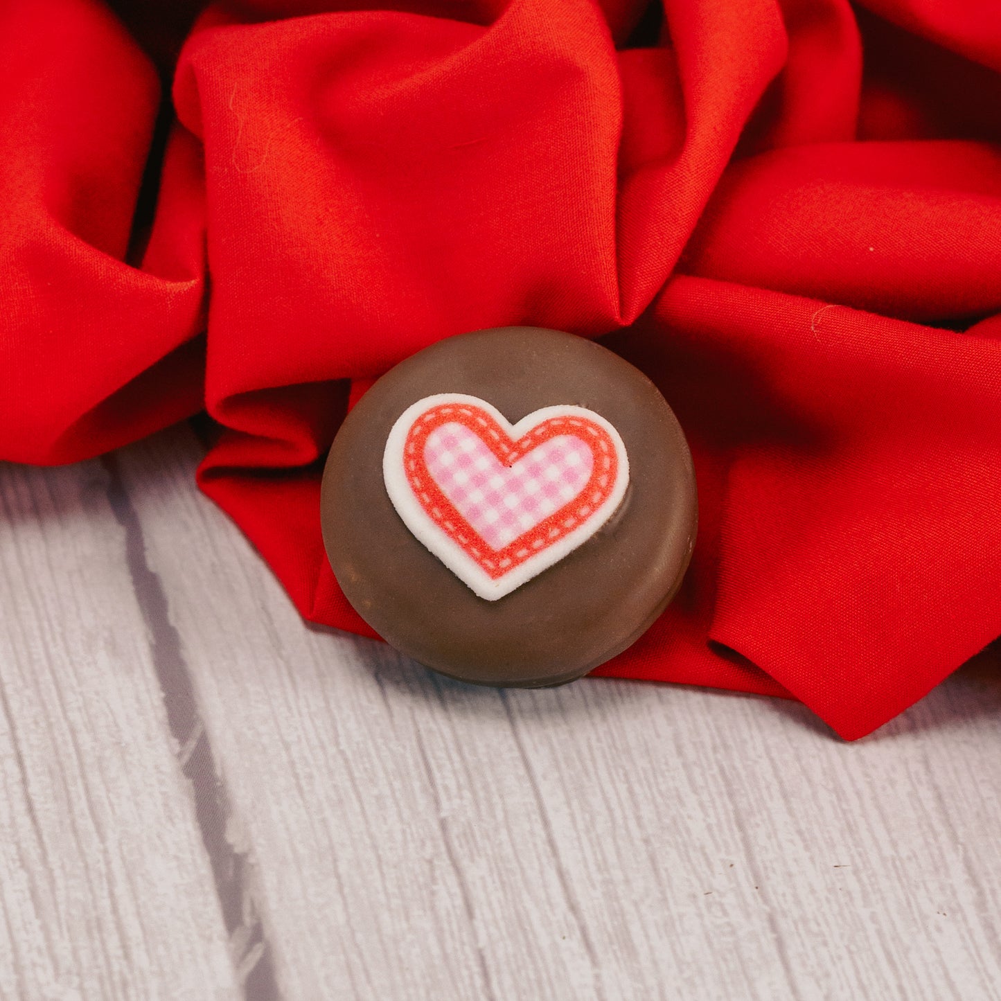 Milk chocolate Oreo cookie with a sugar heart decoration on top