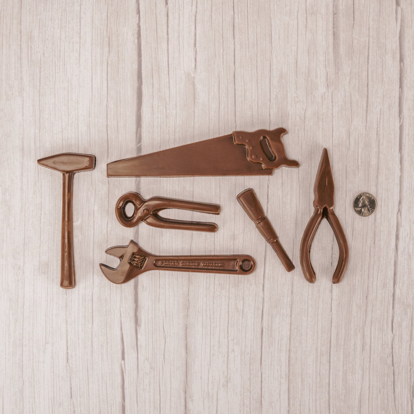 A collection of tools that are made out of milk chocolate and assembled in a box altogether.