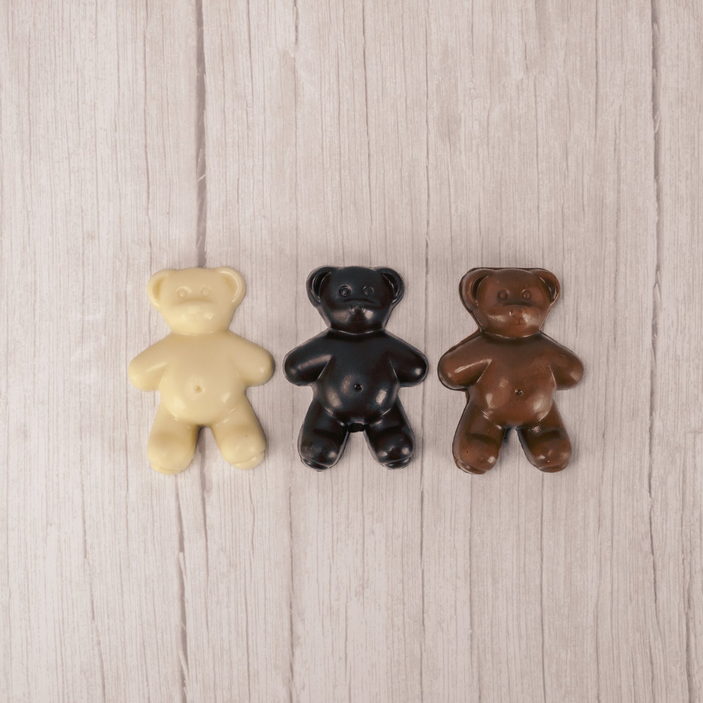 Solid milk chocolate, dark chocolate, and white coating teddy bears.
