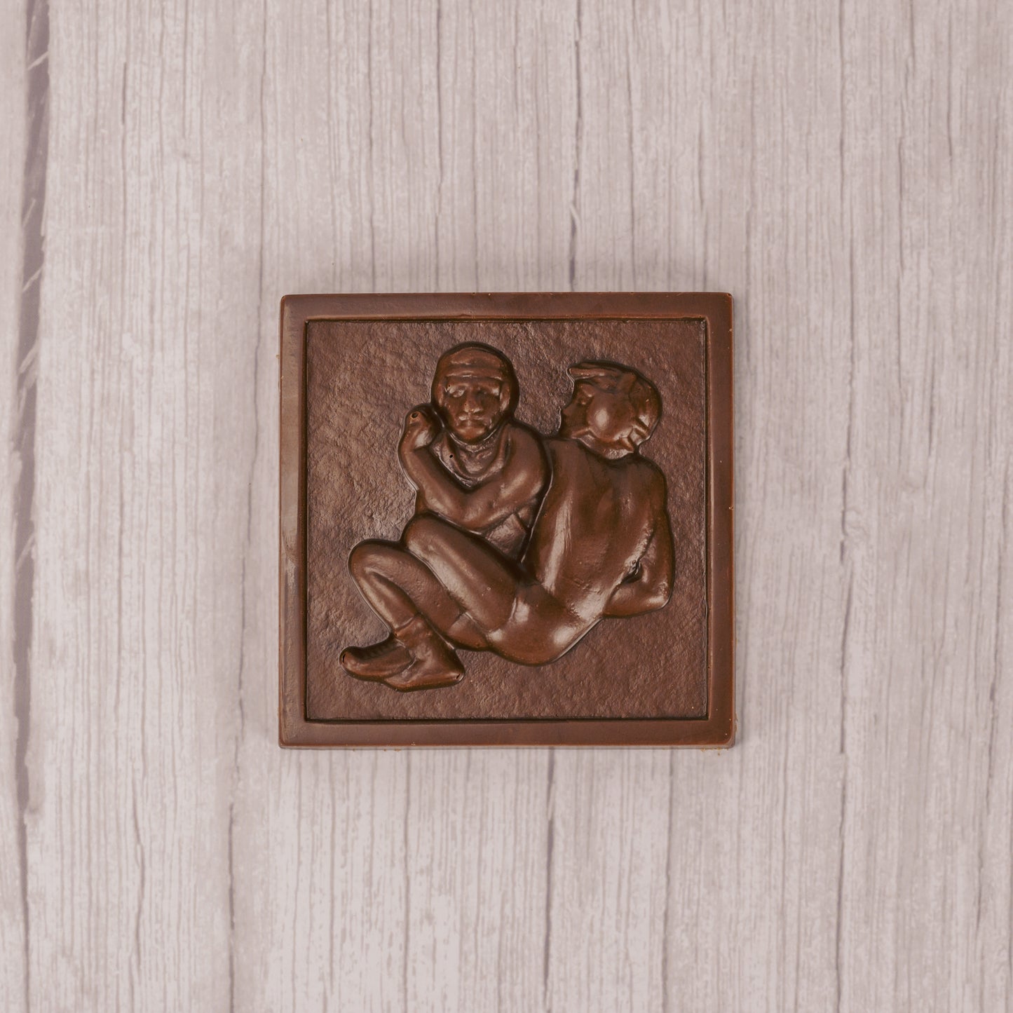 A square shape of two wrestlers in milk chocolate.