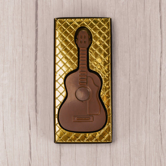 milk chocolate guitar placed in a box