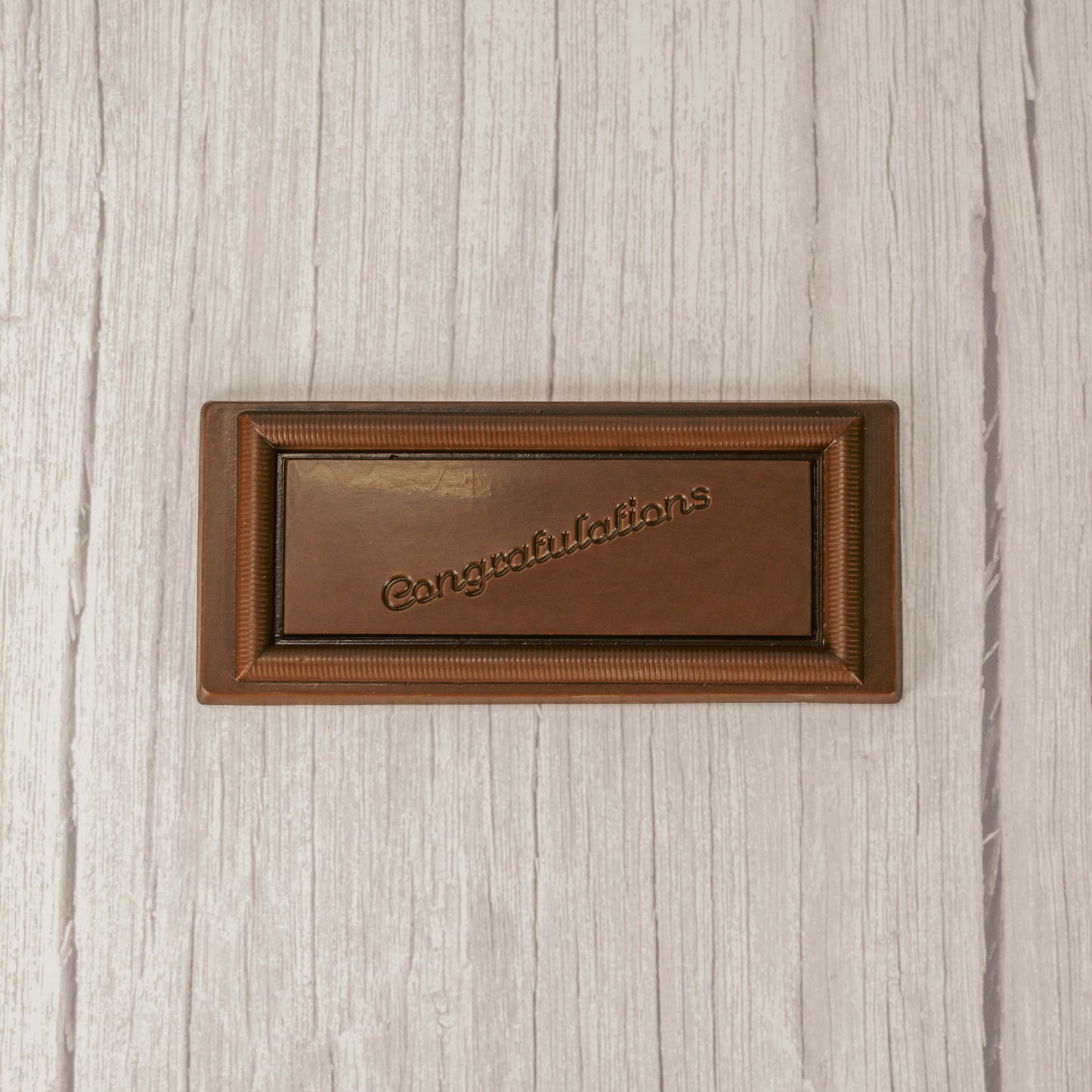 a rectangle solid milk chocolate bar that reads "Congratulations"