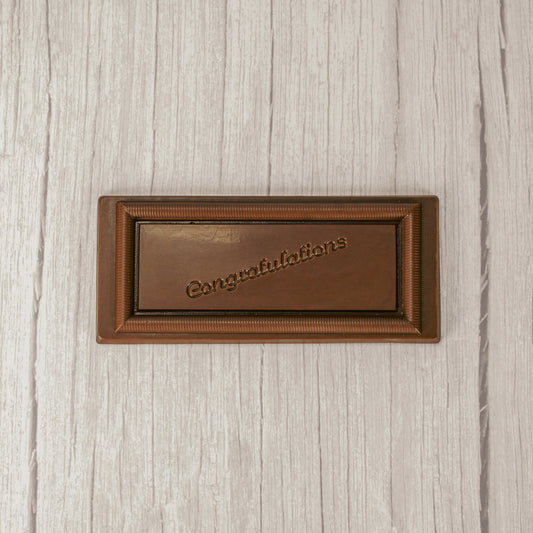 a rectangle solid milk chocolate bar that reads "Congratulations"