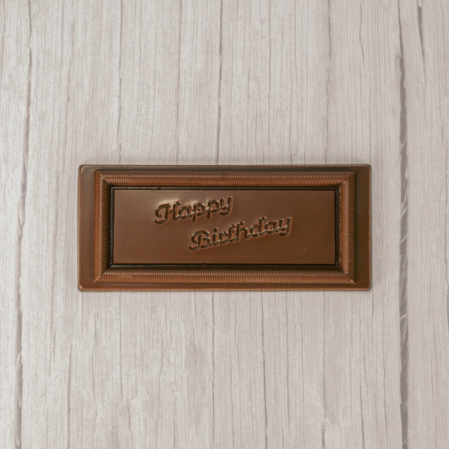 a rectangle solid milk chocolate bar that reads "Happy Birthday"