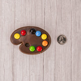 A painter's palette in milk chocolate  with M&Ms representing paint colors.
