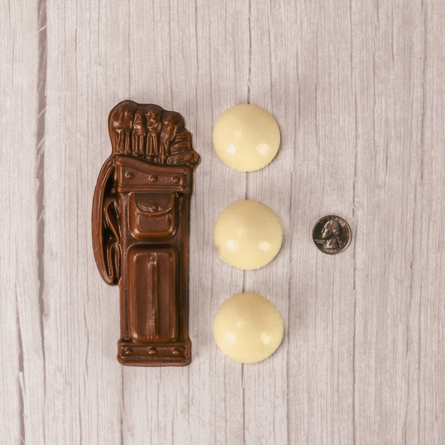 white coating golf balls and milk chocolate golf bag packaged together in a box.