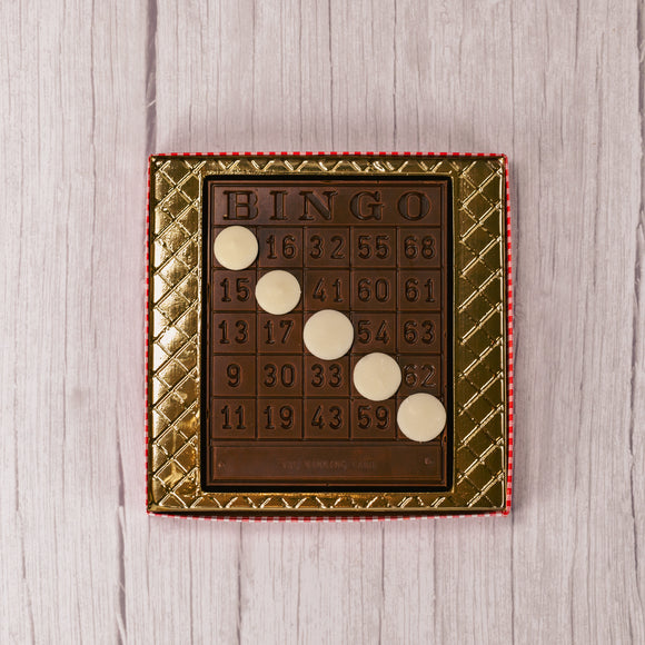 a milk chocolate bingo board with white coating discs to cover spots