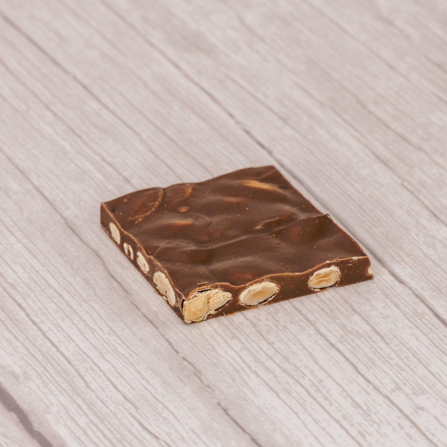 Milk chocolate with almonds. Cut into 2 inch by 2 inch squares. Approximately 16 pieces in a pound box.