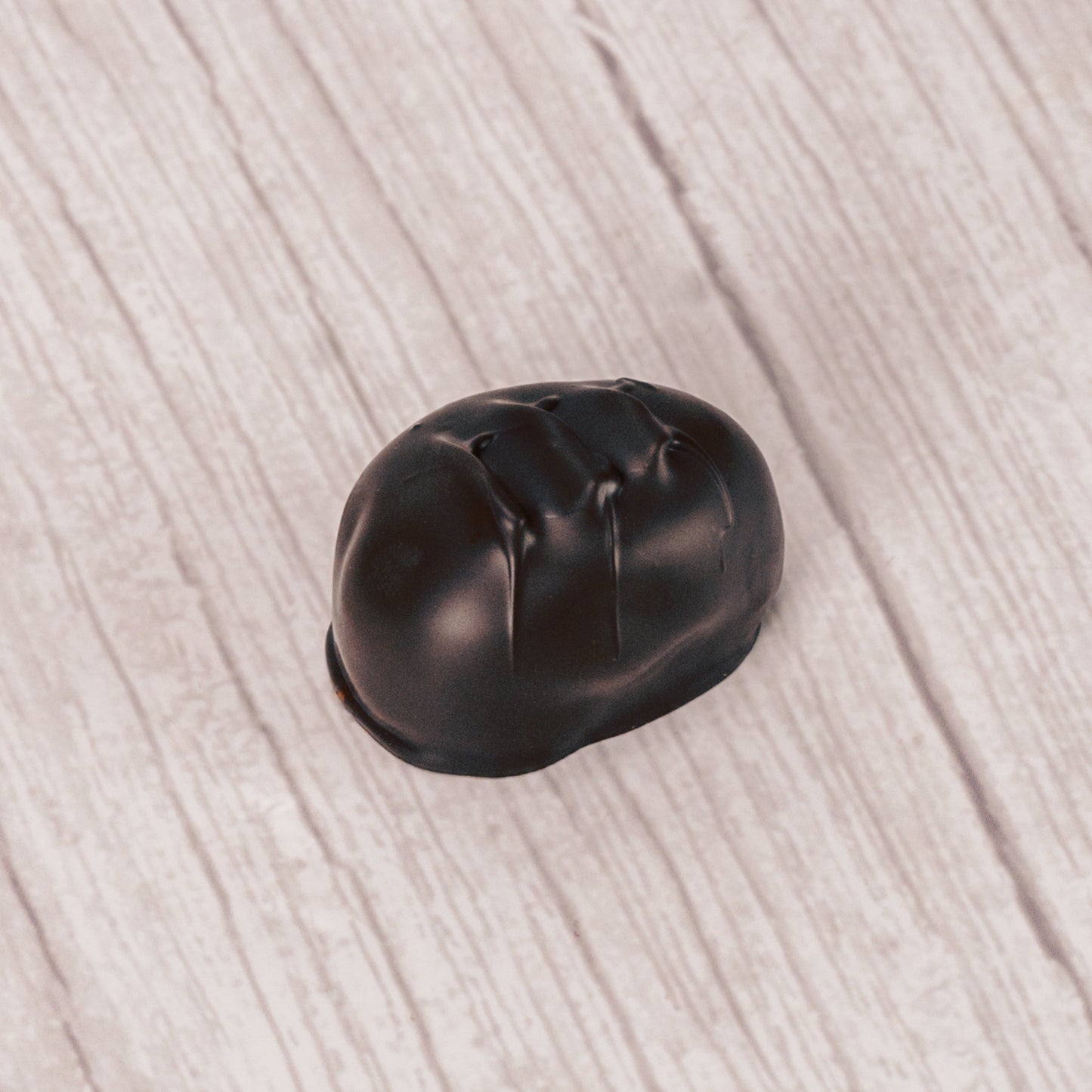 coconut cream with shreds of coconut pieces covered in rich dark chocolate in a pound box.