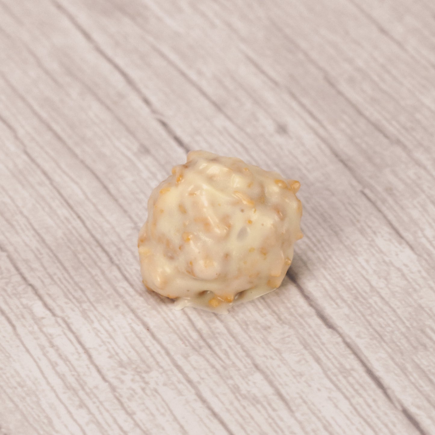 a pound of fudgy chocolate centers dipped in white coating mixed with toasted coconut.