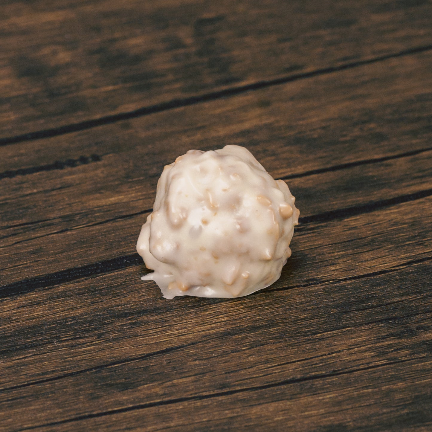 a pound of fudgy chocolate centers dipped in white coating mixed with toasted coconut.