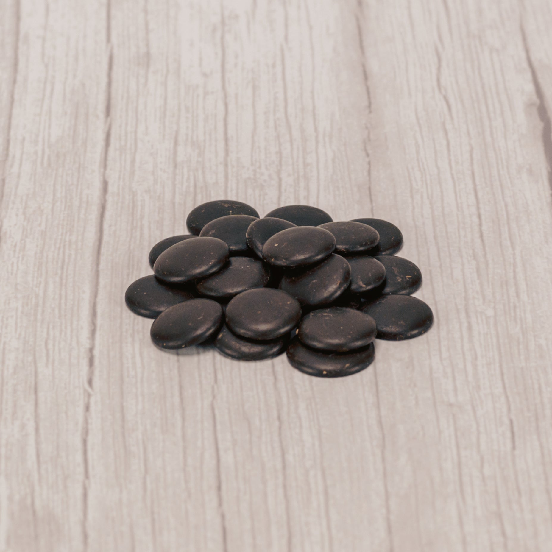 small bite size discs of bittersweet chocolate in a 1 oz. bag.