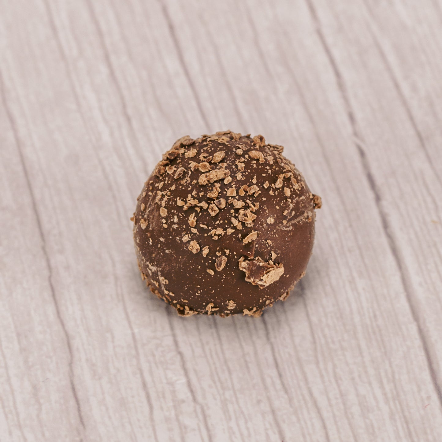 milk chocolate truffle with milk chocolate sprinkles on top